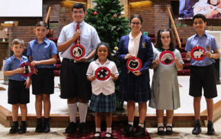 Kids holding Jesse Tree symbols